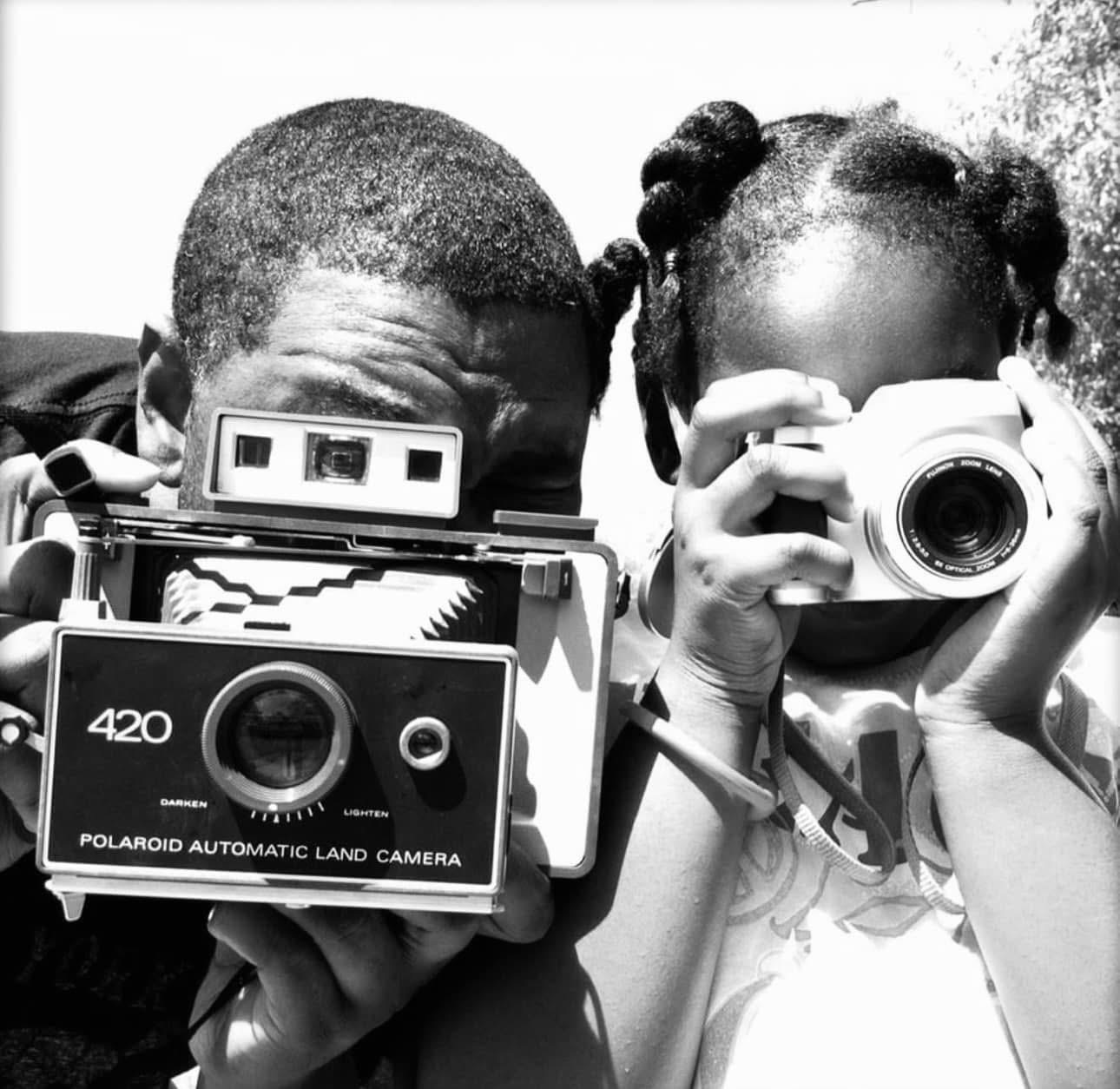 Tiayla as a child holding a camera